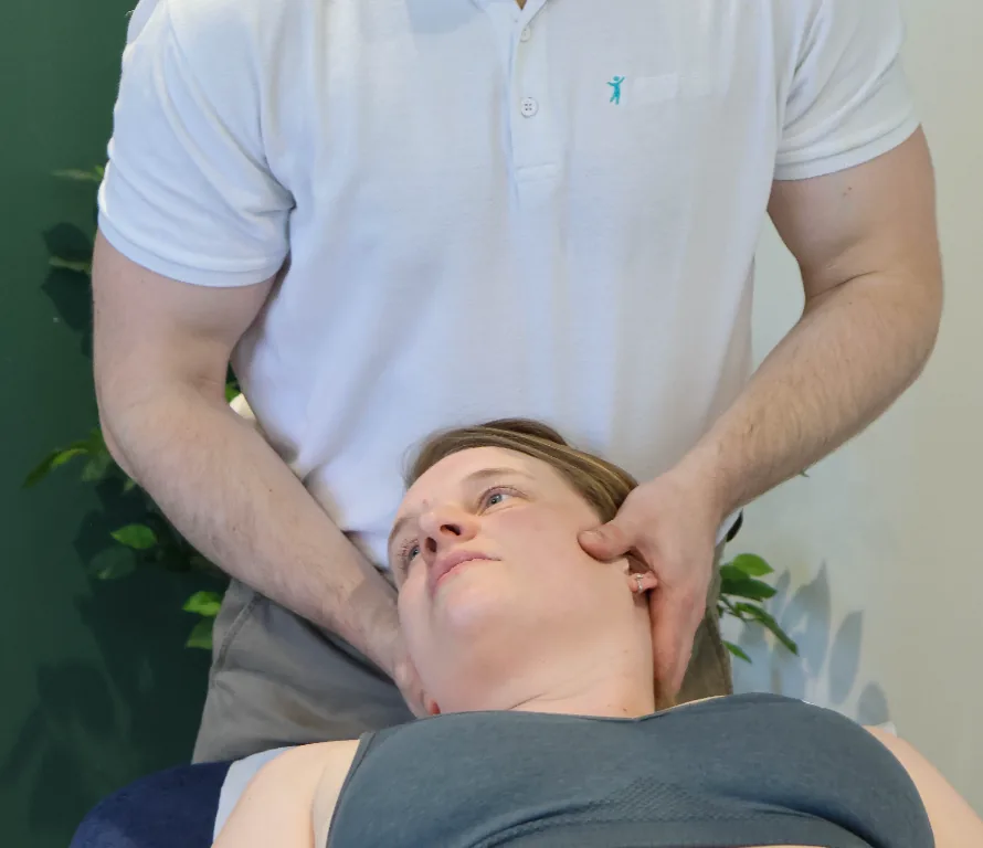 Josh Devine performing neck and shoulder treatment on patient